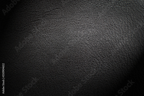 Black leather texture. Abstract background of dark leather with small roughness and scuffs