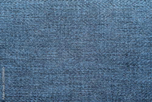 Close-up long and wide texture of natural blue fabric or cloth in light blue color. Fabric texture of natural cotton or linen textile material. Blue canvas background