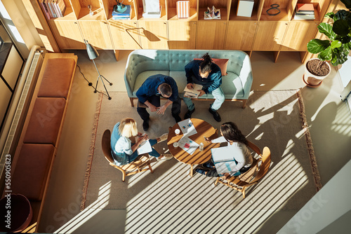 Diverse businesspeople discussing charts during a casual office meeting