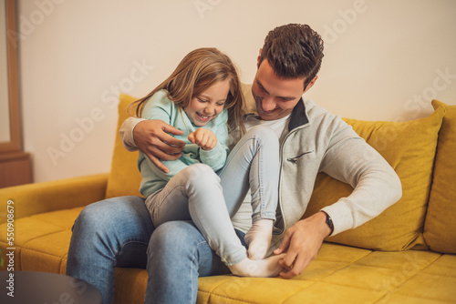 Obraz na plátne Happy father and daughter enjoy spending time together at their home