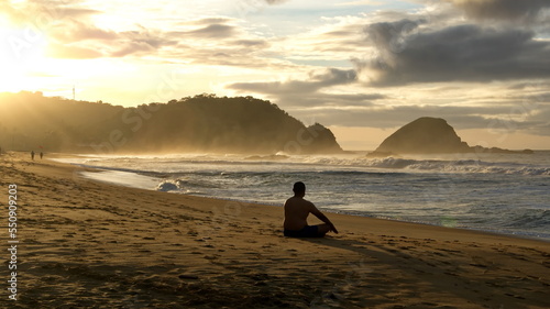 Silhouette of a man meditating on the beach at surise, in Zipolite, Mexico photo