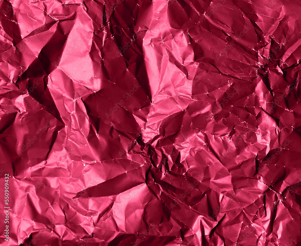 Photo of crumpled foil texture in trendy viva magenta color Photo of crumpled foil texture in trendy viva magenta color