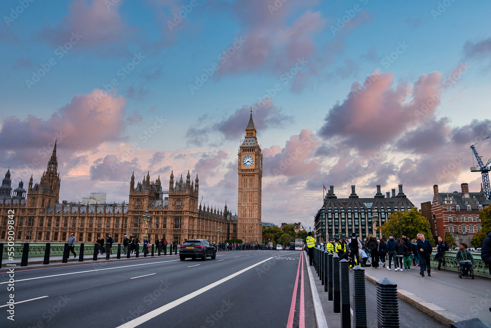 Beautiful Westminster in London with people crossing the bridge. Amazing details after renovation of the Big Ben.