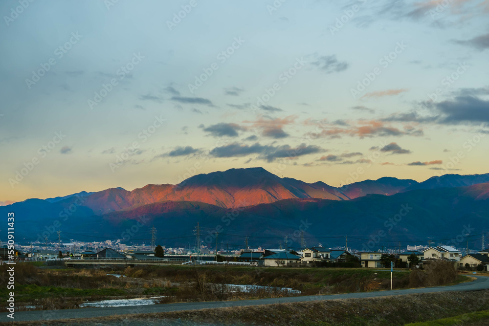 夕日に照らされる山と松本市街地　