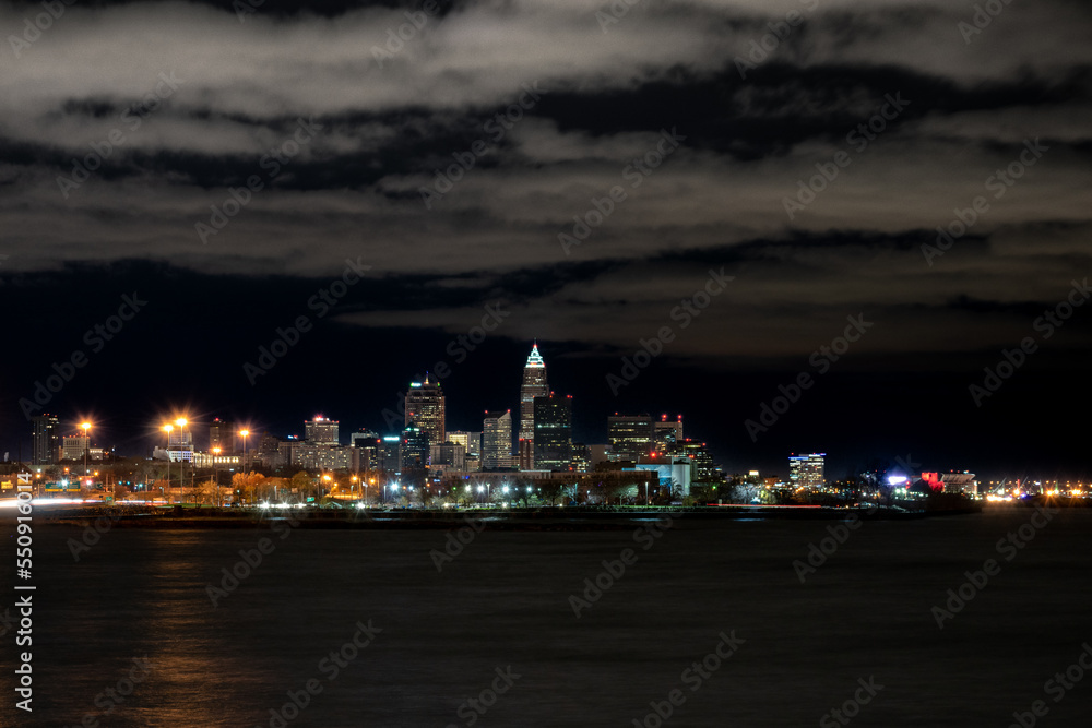 Cleveland skyline during cloudy night from far away.
