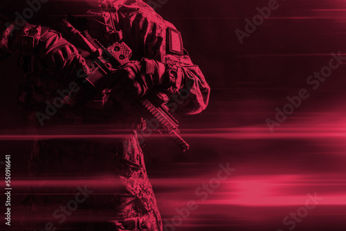 Special forces soldier with rifle on dark background. Color of the year 2023  viva magenta.