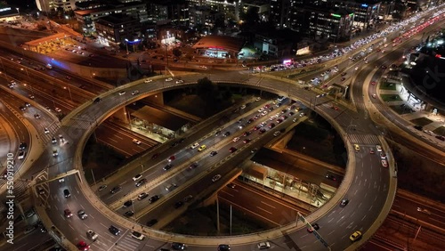 Aerial drone night video of illuminated ring road in Kifisias and Attiki odos avenues, a popular multilevel junction circular road, Attica, Greece photo