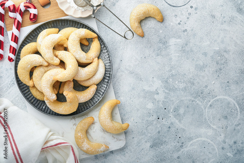 Christmas cookies crescents. Homemade traditional Christmas cookies Vanilla crescents in rustic plate with christmas decorations on gray old background. Food pattern. Holiday baking concept.