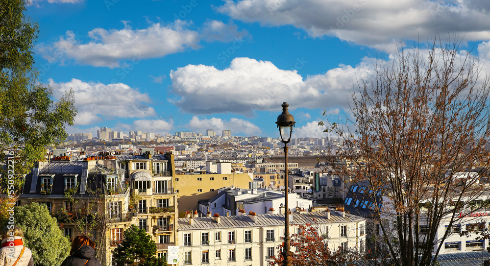 Paris (Montmartre), France - November 25.. 2022: Southeast overlook of paris skyline from Sacre coeur viewpoint on sunny autumn day