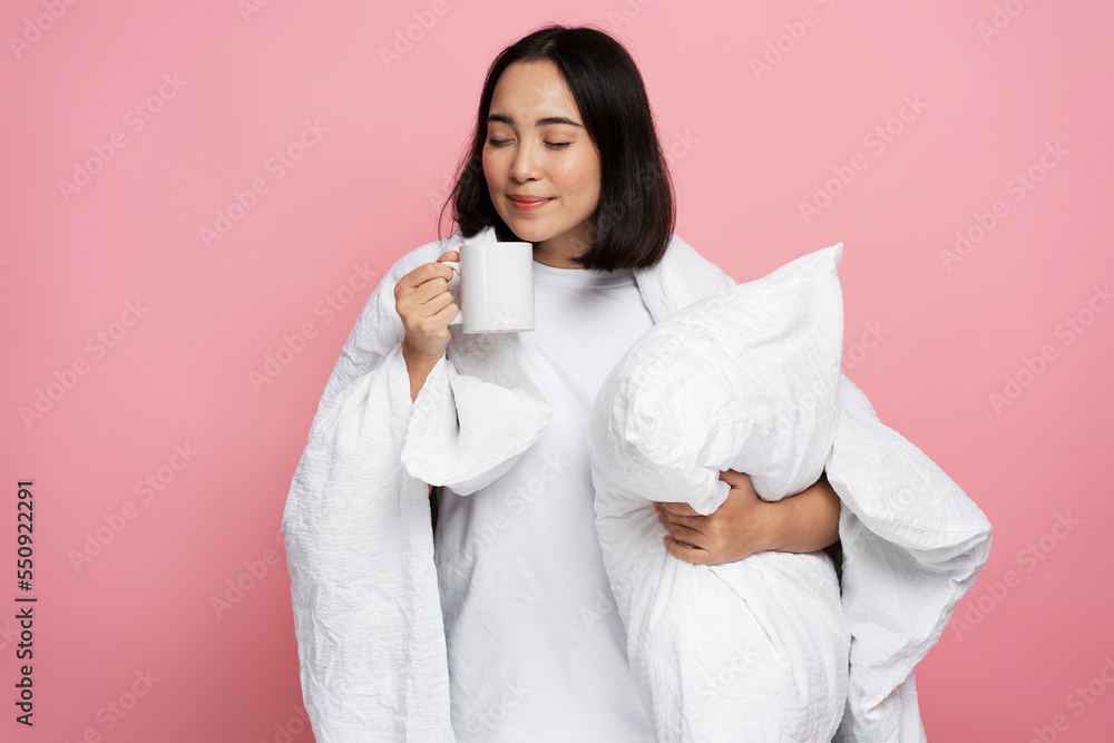 Happy calm woman hugging pillow and drinking morning coffee Happy calm woman hugging pillow and drinking morning coffee