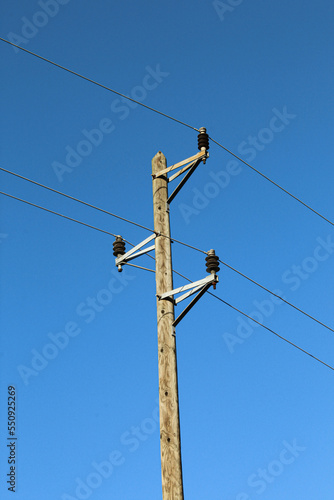 Wooden pole with power lines. Electricity transmission cables