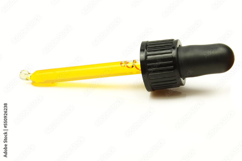 Oil pipette isolated on white background. Natural essence extract of yellow substance in dropper Oil pipette isolated on white background. Natural essence extract of yellow substance in dropper
