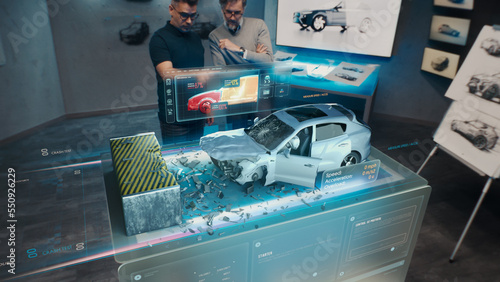 Two engineers Developers standing in design studio near futuristic holographic table and make a test in a 3d car crash test simulator, which simulates a road accident check the safety