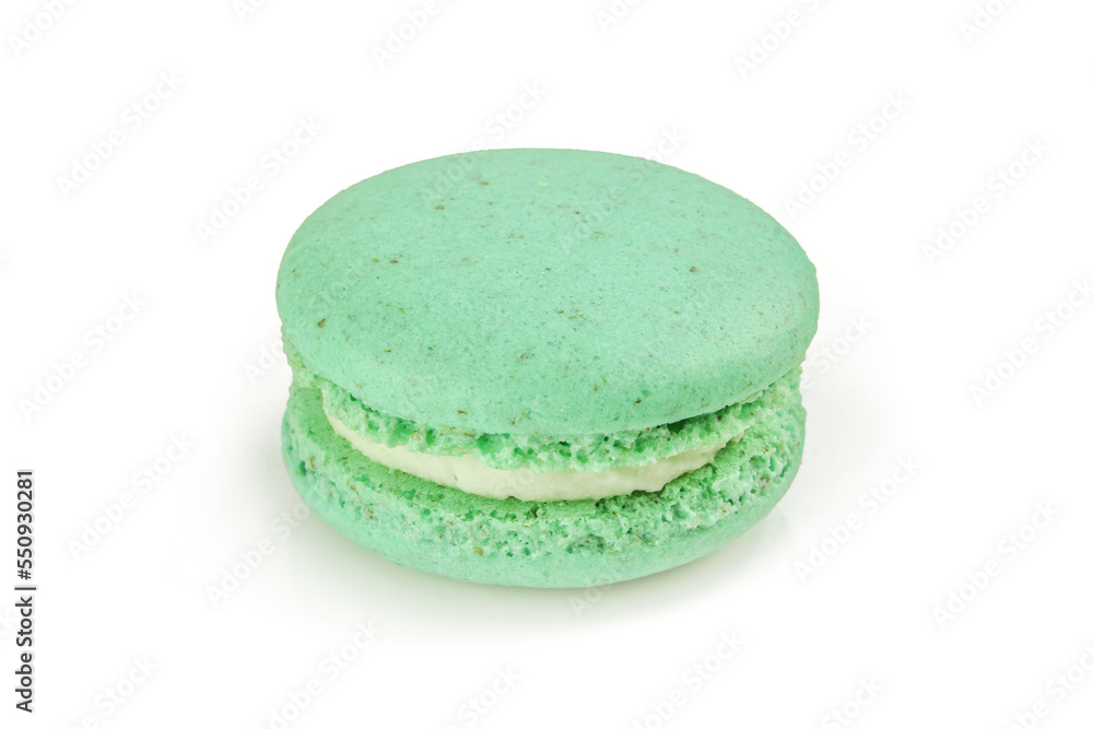 Single green macaroon with white filling cream isolated on white background. French macaron delicacy