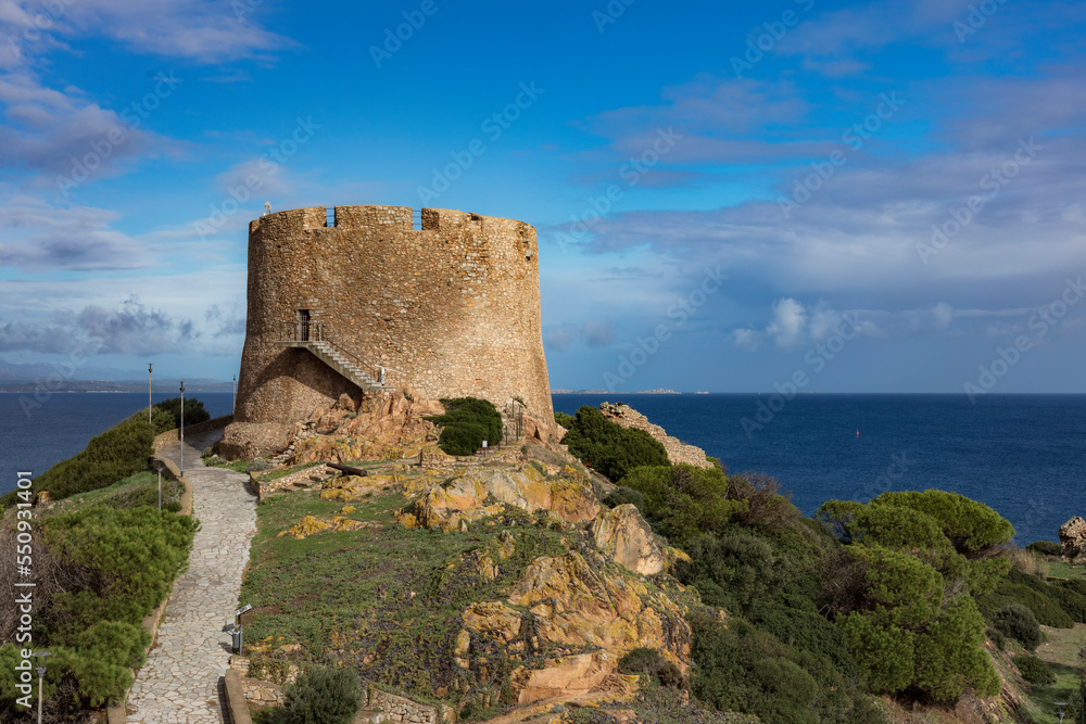 Old Spanish turret, torre spagnola, torre longosardo tower, in Santa Teresa Gallura, Sardinia. Corsica on the background.