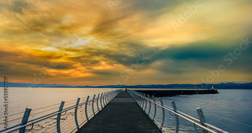 Alone on the Breakwater at Sunset