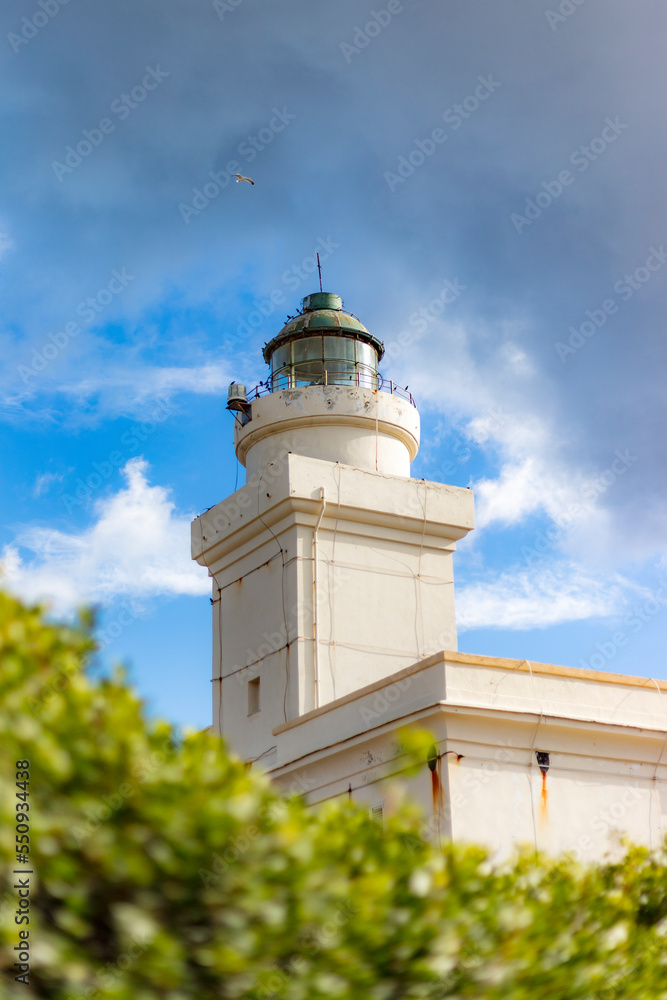 old white lighthouse on the coast, capo testa, santa teresa gallura.