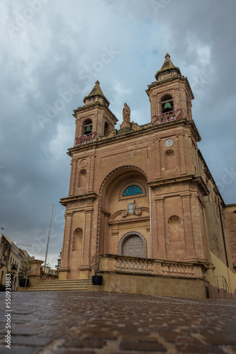 Church of Santwarju tal-Madonna ta' Pompei in the city of Marsaxlokk on a rainy day. Reflections seen on the ground.