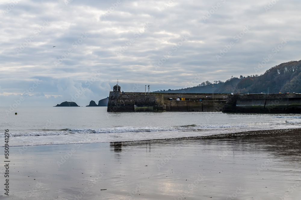 A view from the beach towards the harbour as the tide turns in Saundersfoot, Wales in winter