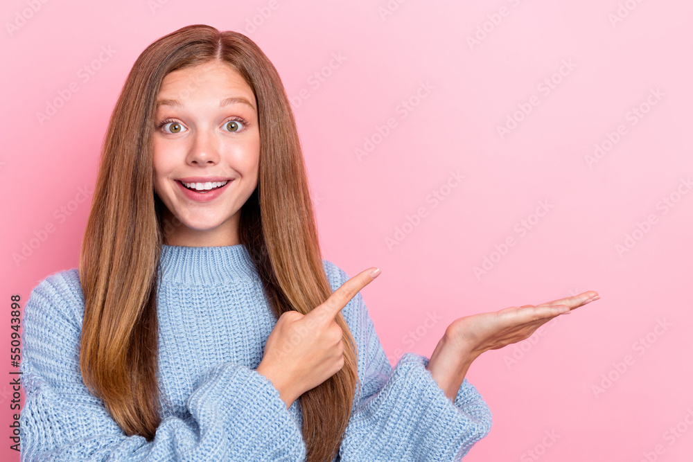 Photo of funny cheerful lady trendy clothes arm demonstrate empty space recommendation offer proposition isolated on pink color background Photo of funny cheerful lady trendy clothes arm demonstrate empty space recommendation offer proposition isolated on pink color background