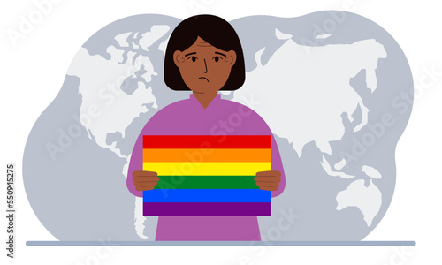 A woman holds an lgbt flag in his hands against the backdrop of a world map.