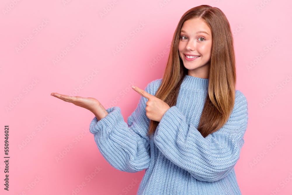 Photo of cheerful adorable lady wear knitted sweater arm direct empty space banner offer discount isolated on pink color background Photo of cheerful adorable lady wear knitted sweater arm direct empty space banner offer discount isolated on pink color background