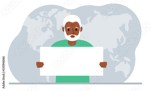 The concept of world attention. A man holds a white poster in his hands against the background of a world map.