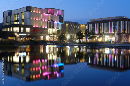 colourful modern buildings, with reflections, at night