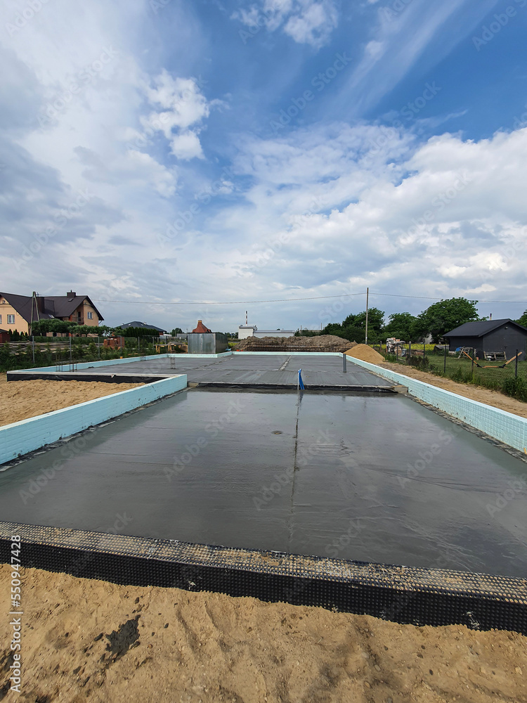 Fototapeta premium Freshly poured foundation in new building deflecting water