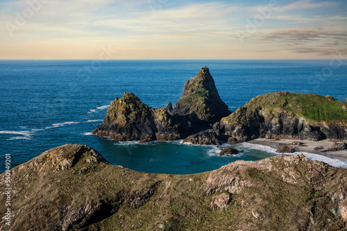 Beautiful dawn landscape over Kynance Cove in Cornwall England with vibrant sky and beautiful turquoise ocean