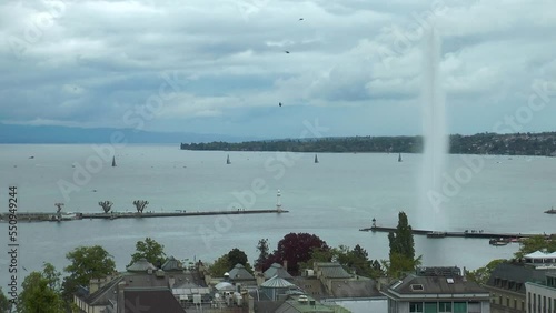 Switzerland. Beautiful summer evening landscape of Lake Geneva with picturesque shores and pleasure ship against Alpine mountains. Geneva harbour with a famous fountain.