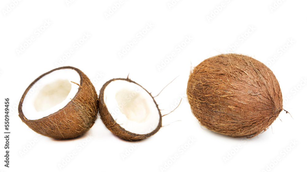 Coconuts whole and halved isolated on white background.