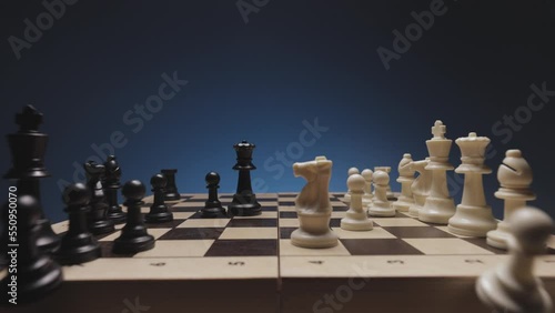Chess in slowmo falls from the board to the camera. The camera is fixed on a chessboard.
