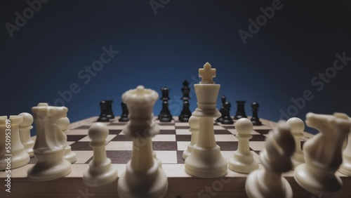 Chess in slowmo falls from the board to the camera. The camera is fixed on a chessboard.