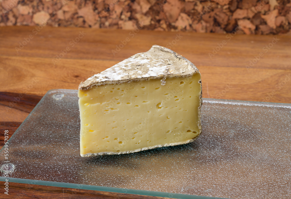 Pieces of cheese tomme de montagne or tomme de savoie made from cow milk in French Alps
