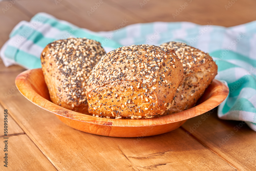 Bun with poppy seeds and sesame on the wooden table. Bun with poppy seeds and sesame on the wooden table.