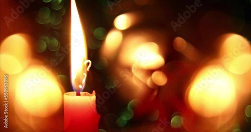 Merry Christmas background. Beautiful glowing candle and bokeh effect background. Christmas lights.