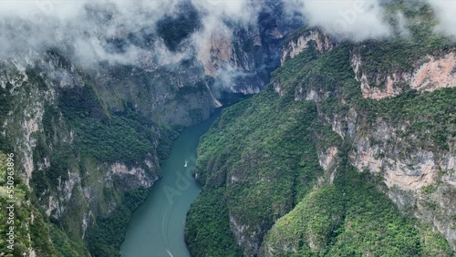 Aerial view of the majestic Canyon del Sumidero in Mexico. Flight over the canyon in the clouds.