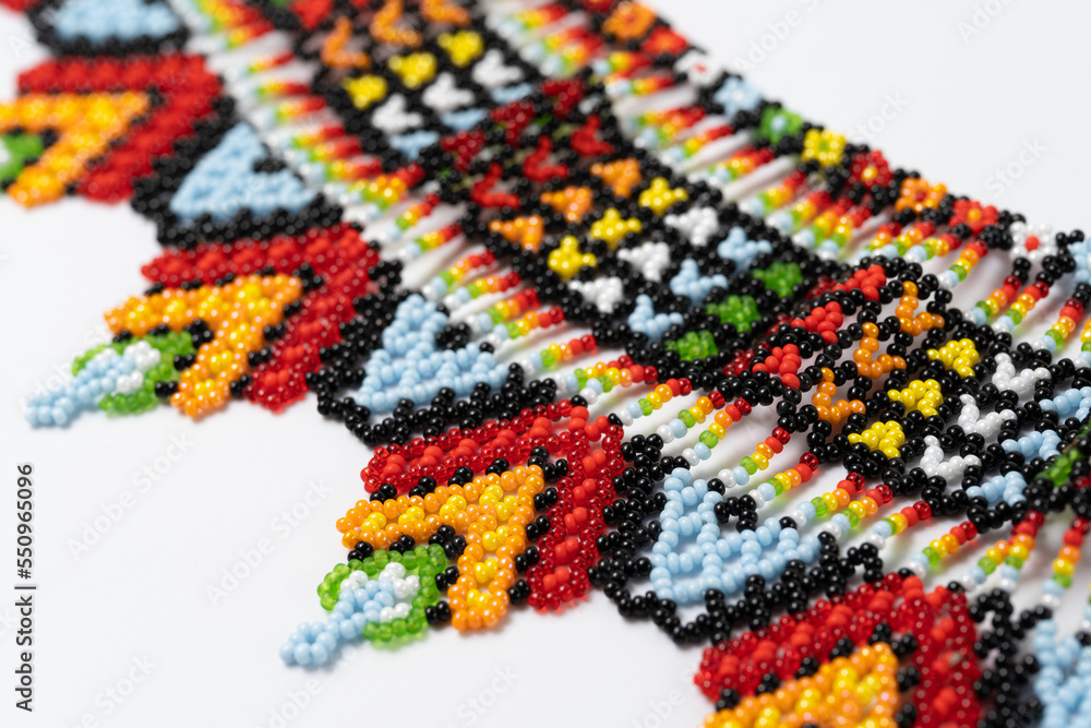 handmade colorful bead necklace close-up isolated on white background.