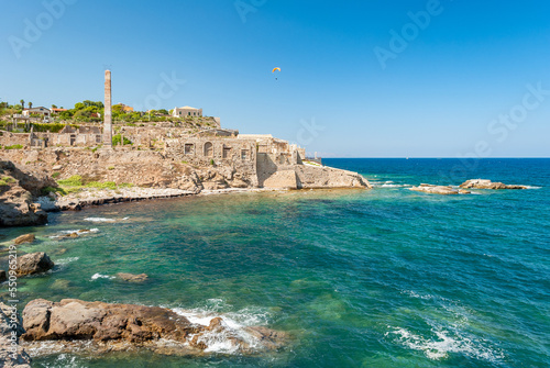 Coastline of Portopalo, in southern Sicily, with the ruins of an old factory for the manufacturing of tuna fish photo