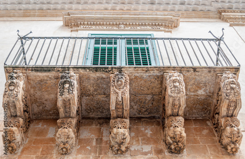 Balcony with baroque decorations in a house of Noto, in eastern Sicily