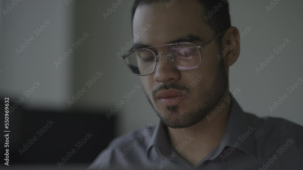 Close up of businessman working late on computer / Provo, Utah, United States Close up of businessman working late on computer / Provo, Utah, United States