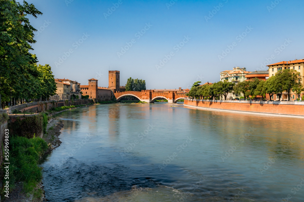 View of Adige river and medieval stone bridge of Ponte Scaligero in Verona, built in 14th century near Castelvecchio. Italy.