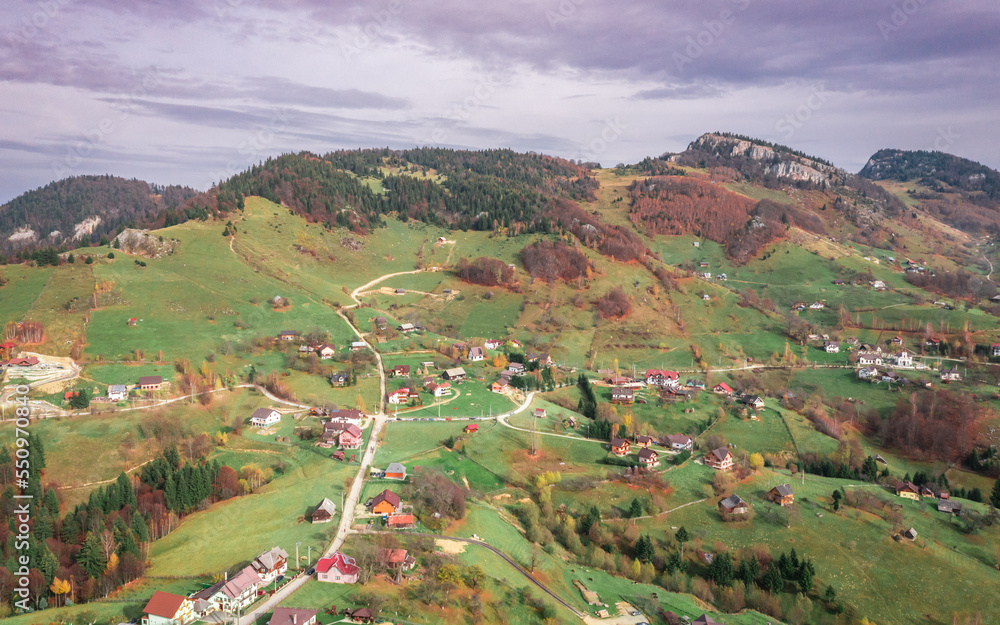 Beautiful landscape aerial view with Carpathian Mountains in Brasov county Romania captured in autumn 