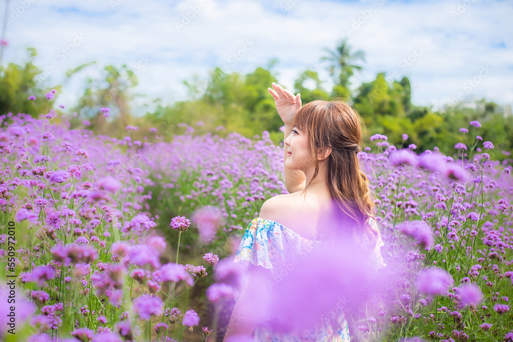 woman wearing a long dress in a field of lavende flowers exudes a relaxed and freedom. Soft and select focus woman wearing a long dress in a field of lavende flowers exudes a relaxed and freedom. Soft and select focus