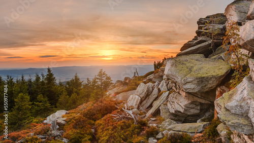 Eastern Sudetes, mountain landscape, rocky trail on the hiking trail leading to the top of Czarna Gora. The trail is lit by the setting sun.