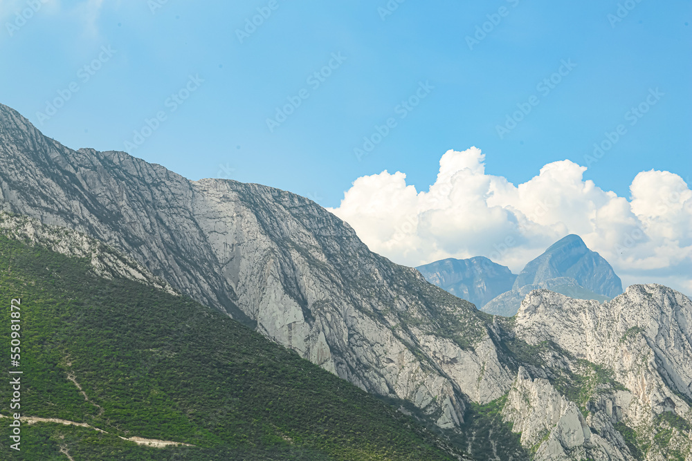 Majestic mountain landscape under blue sky with clouds