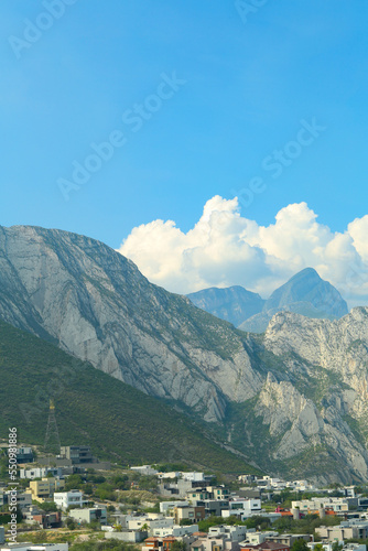 Small town near majestic mountain landscape covered with greenery