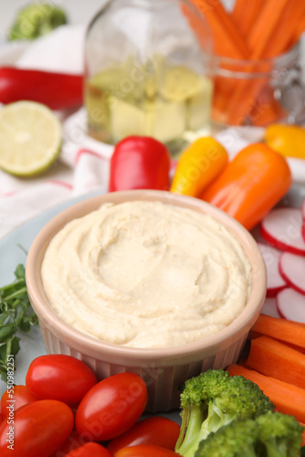 Plate with delicious hummus and fresh vegetables, closeup