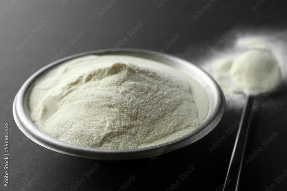 Bowl and spoon of agar-agar powder on black background, closeup Bowl and spoon of agar-agar powder on black background, closeup